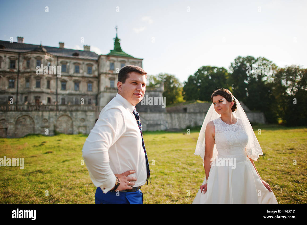 Young wedding couple on background old castle Stock Photo - Alamy
