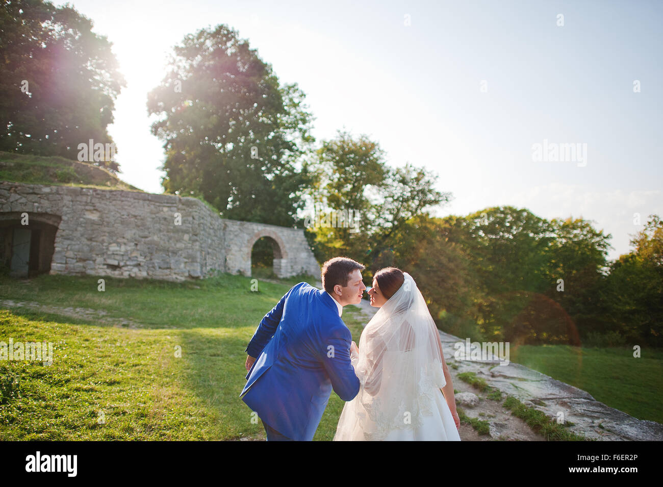 Young wedding couple on background old castle Stock Photo - Alamy