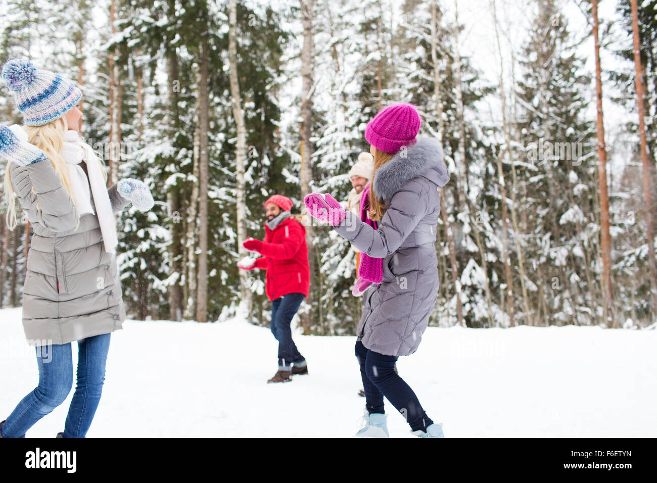 happy friends playing snowball in winter forest Stock Photo - Alamy