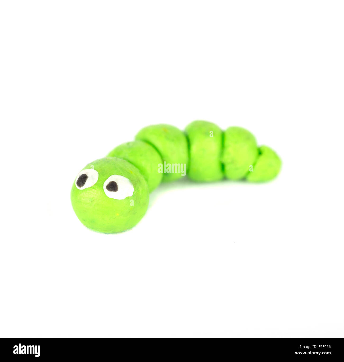 Hand made plasticine or modeling clay figure of a caterpillar on white background Stock Photo