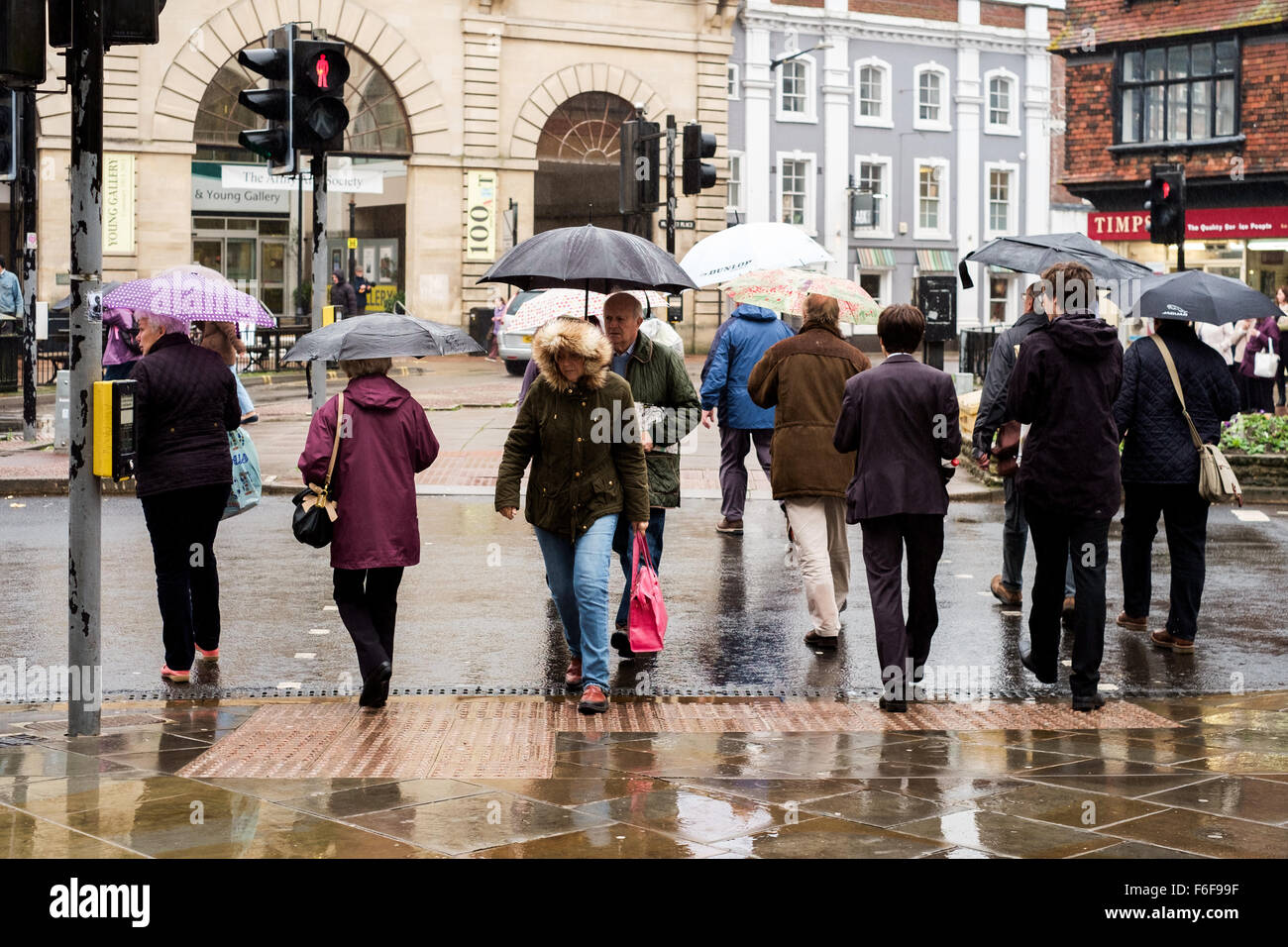 Uk Weather A Very Wet Day For Shopping In Salisbury With People Crossing The Road Using Umbrellas To Protect Them From Heavy Rain Uk Weather A Very Wet Day For Shopping In Salisbury With People Crossing The Road Using Umbrellas To Protect Them From Heavy Rain