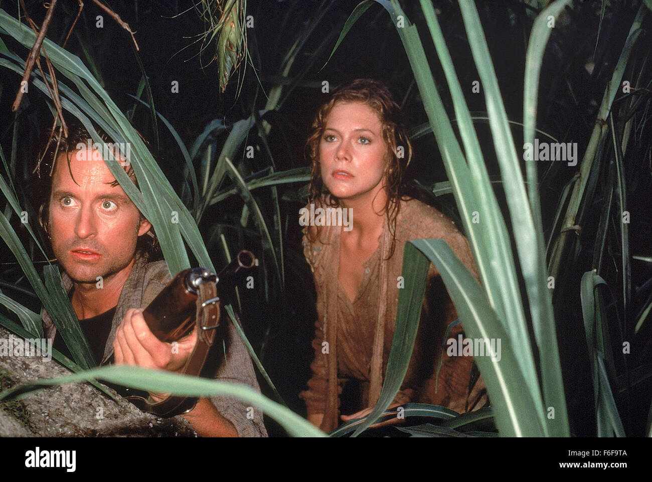 Mar 30, 1984; Los Angeles, CA, USA; Actor MICHAEL DOUGLAS stars as Jack T. Colton and KATHLEEN TURNER as Joan Wilder in the 20th Century Fox action comedy, 'Romancing the Stone.' Directed by Robert Zemeckis. Stock Photo