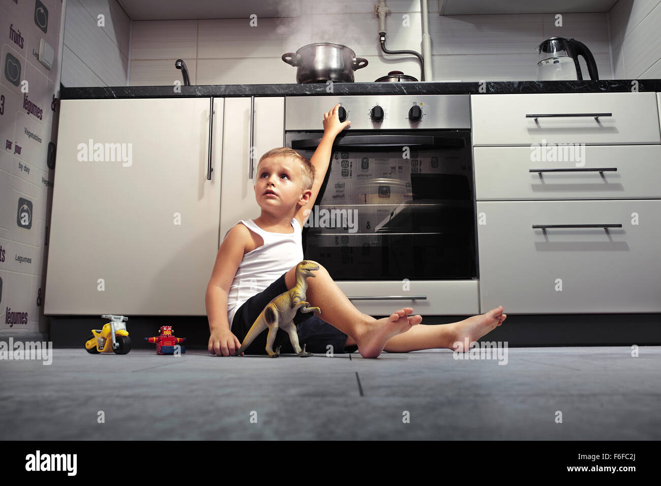 accident prevention. The child unattended playing in the kitchen with a ...