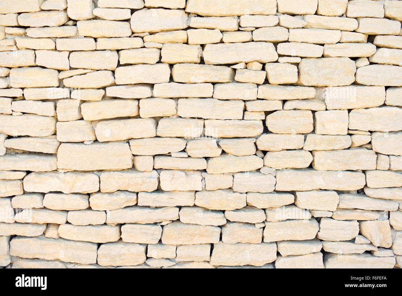 Stone wall background, pattern, texture, wallpaper. Exterior construction in Provence, Cote Azur, France, Europe. Stock Photo