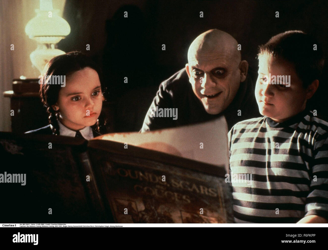 RELEASE DATE: 22 November 1991. MOVIE TITLE: The Addams Family - STUDIO: Paramount Pictures. PLOT: Con artists plan to fleece the eccentric family using an accomplice who claims to be their long lost Uncle Fester. PICTURED: CHRISTINA RICCI as Wednesday Addams with CHRISTOPHER LLOYD as Uncle Fester and JIMMY WORKMAN as Pugsley Addams. Stock Photo