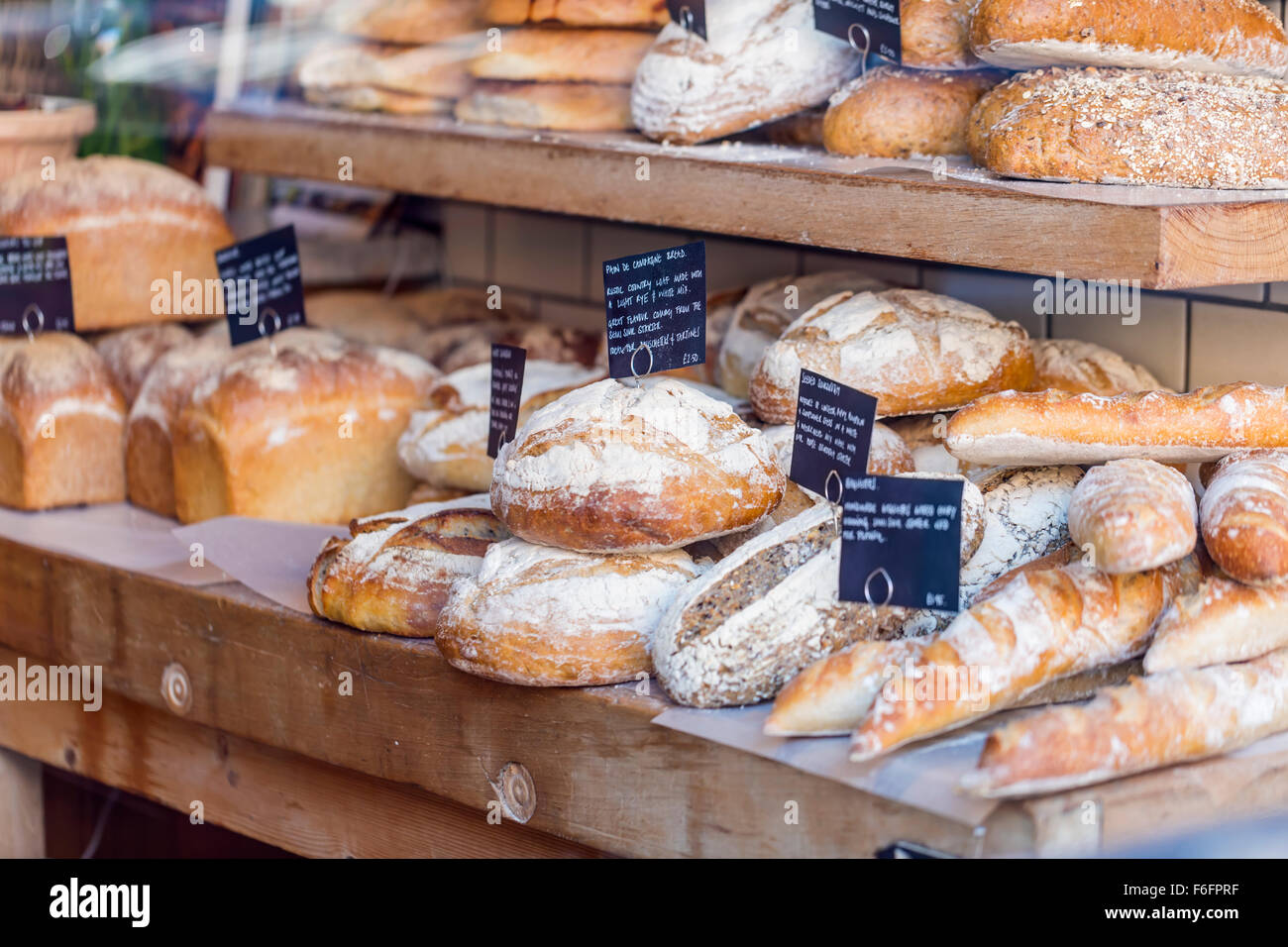 Fresh bread on display in a bakers shop window Stock Photo