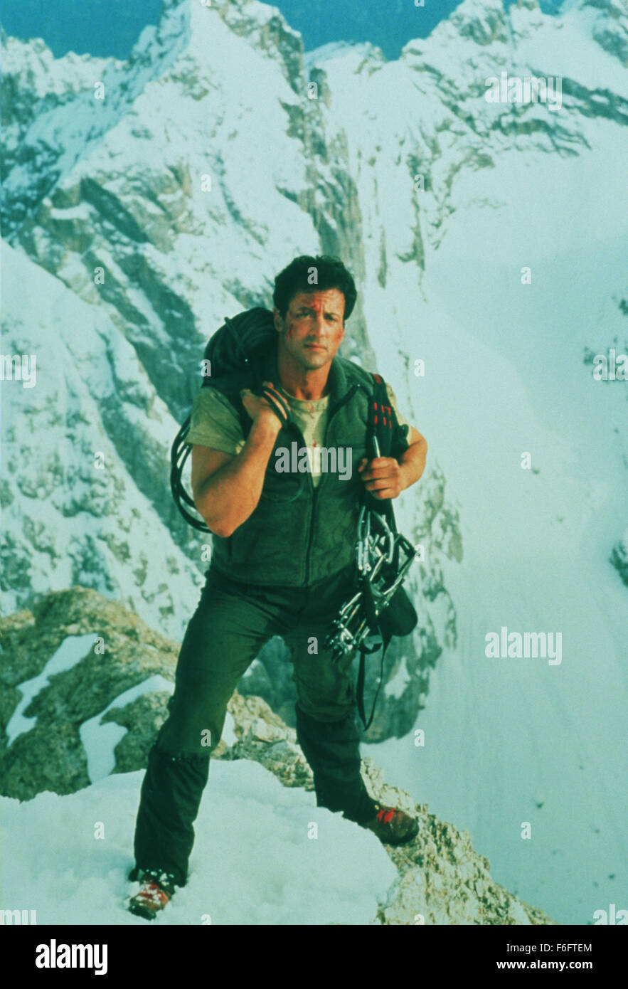 RELEASE DATE: May 28, 1993. MOVIE TITLE: Cliffhanger. STUDIO: Carolco Pictures. PLOT: Whilst crossing a ledge, 4000 feet above the earth, Gabe's friend's equiptment fails to work and she slips out of his hand, falling to the ground. Almost a year later, Gabe is asked to go back to the same mountain range and rescue a group of 'stranded' people. The only catch is that these so called 'stranded' people are infact looking for three boxes filled with $100,000,000 and they need mountain ranger to lead them to them. PICTURED: SYLVESTER STALLONE as Gabe Walker. Stock Photo