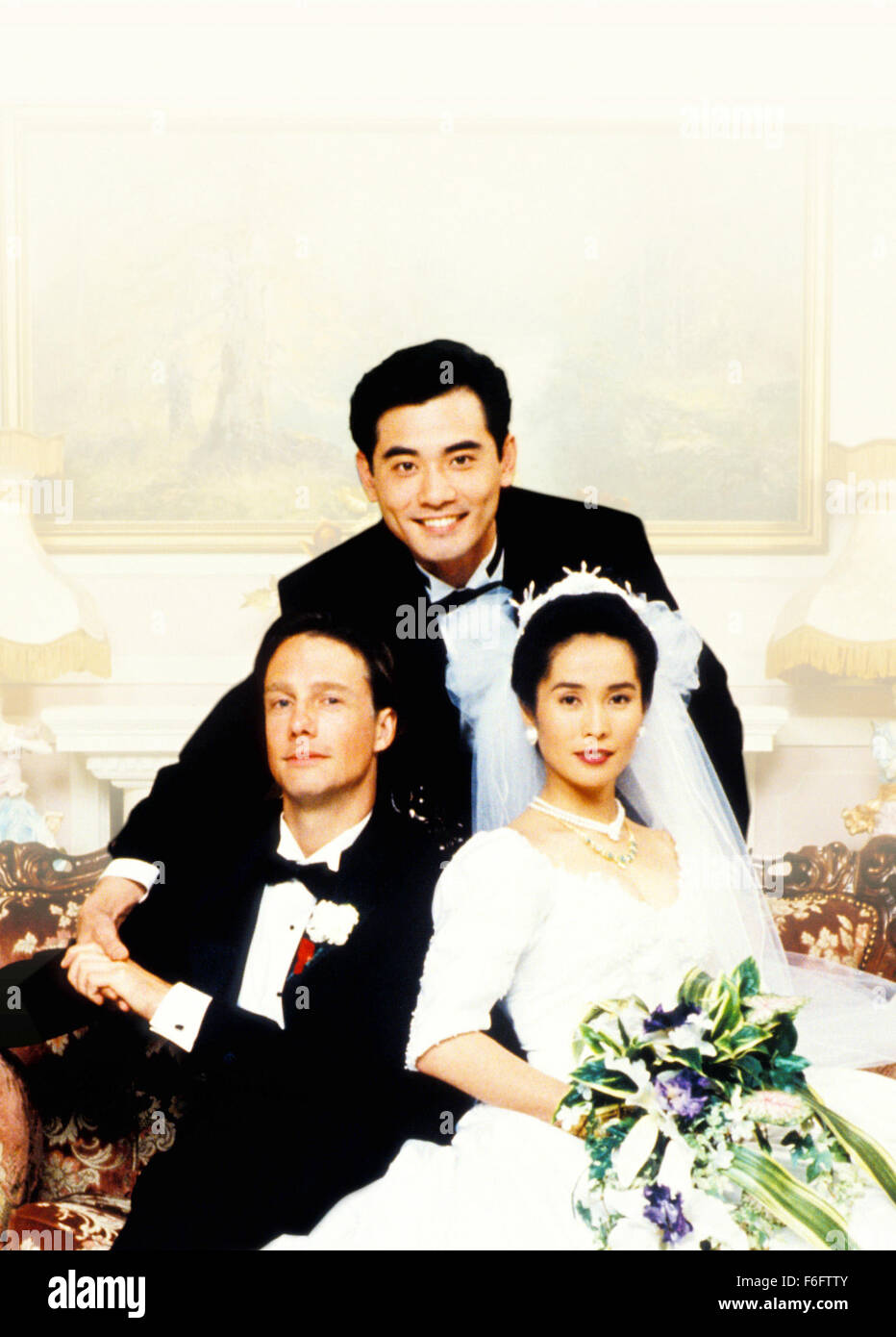 RELEASE DATE: Aug 04, 1993. MOVIE TITLE: The Wedding Banquet aka Hsi yen. STUDIO: The Samuel Goldwyn Company. PLOT: A gay Taiwanese-American man is in a happy long term relationship in Manhattan, but his parents in Taiwan are always pressuring him to marry. His tenant, a young Chinese girl needs to marry an American citizen to obtain her green card, so a deal is made. Complications arise when the joyous parents arrive for the wedding and a huge cross-cultural banquet is arranged to celebrate. PICTURED: MITCHELL LICHTENSTEIN as Simon, WINSTON CHAO as Wai-Tung Gao, MAY CHIN as Wei-Wei, Movie Art Stock Photo