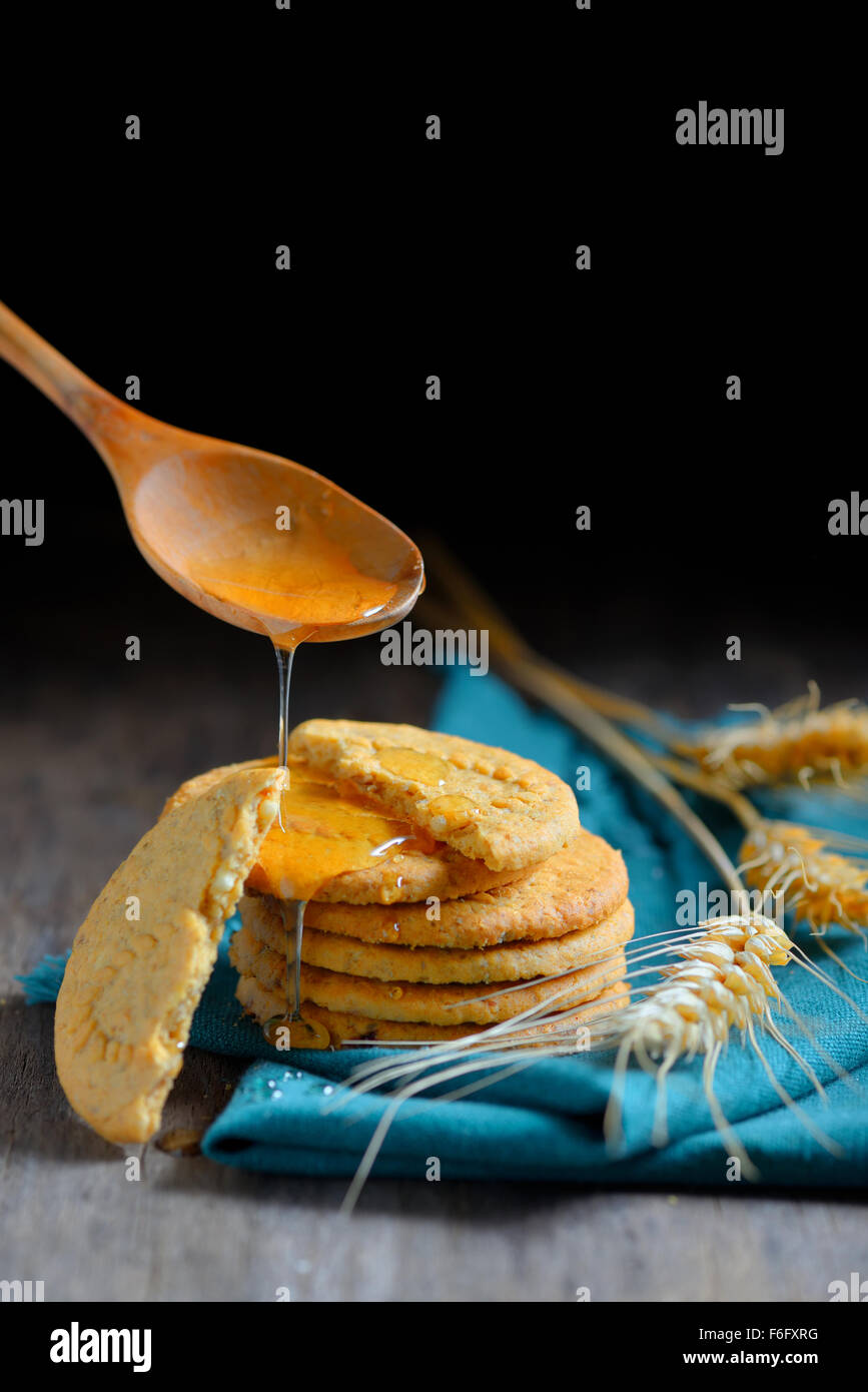 crispy cereal cookies and honey on rustic wooden table Stock Photo