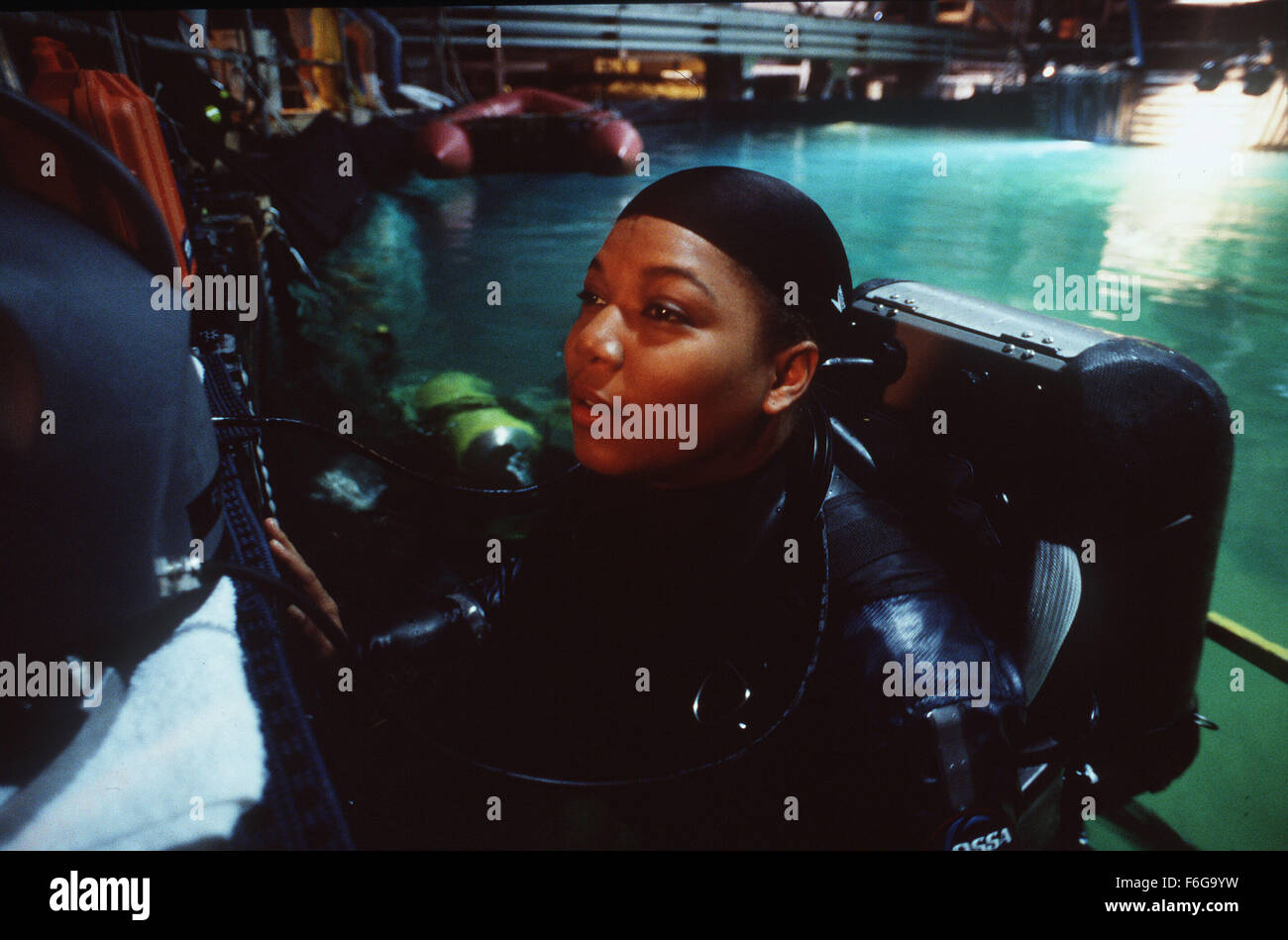 RELEASE DATE: 13 February 1998. MOVIE TITLE: Sphere. STUDIO: Baltimore Pictures. PLOT: 1000 feet below the ocean, navy divers discover an object half a mile long, it is a massive spaceship, undamaged from it's fall from the sky-and at least three hundred years old. PICTURED: QUEEN LATIFAH as Alice 'Teeny' Fletcher. Stock Photo