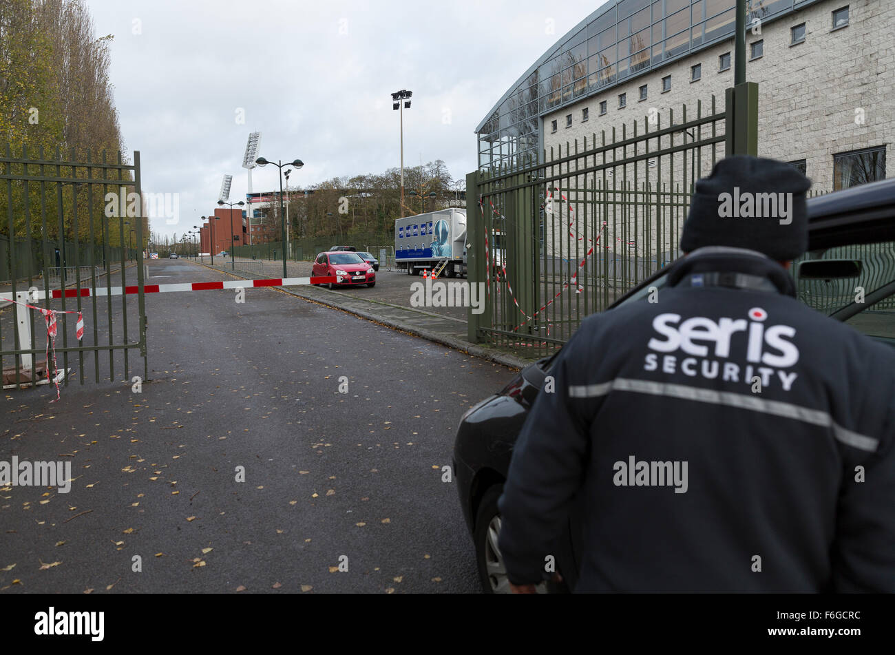 Brussels, Belgium. 17th Nov, 2015. Emplyoees of a security service stands at an entrance gate of the Roi Baudouin stadium in Brussels, Belgium, 17 November 2015. A friendly soccer match between Belgium and Spain was due to be played at the stadium on Tuesday but was cancelled due to security concerns following the Paris terrorist attacks on 13 November. Photo: Thierry Monasse/dpa/Alamy Live News Stock Photo