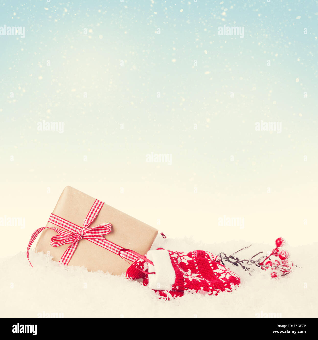 Christmas gift box in snow with background for copy space. Retro toned ...