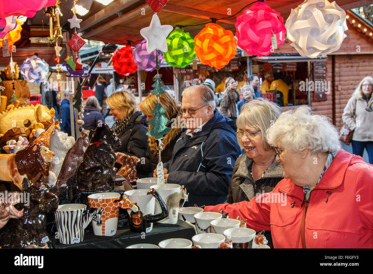 Manchester Christmas market stall busy with elderly female visitors looking at Christmas decorations Stock Photo