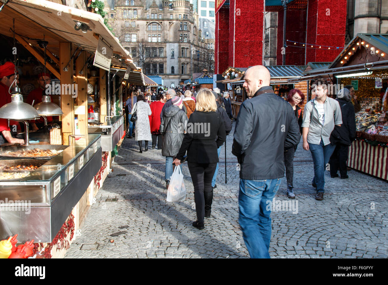 Manchester Christmas market visotors walking next to market stalls Stock Photo