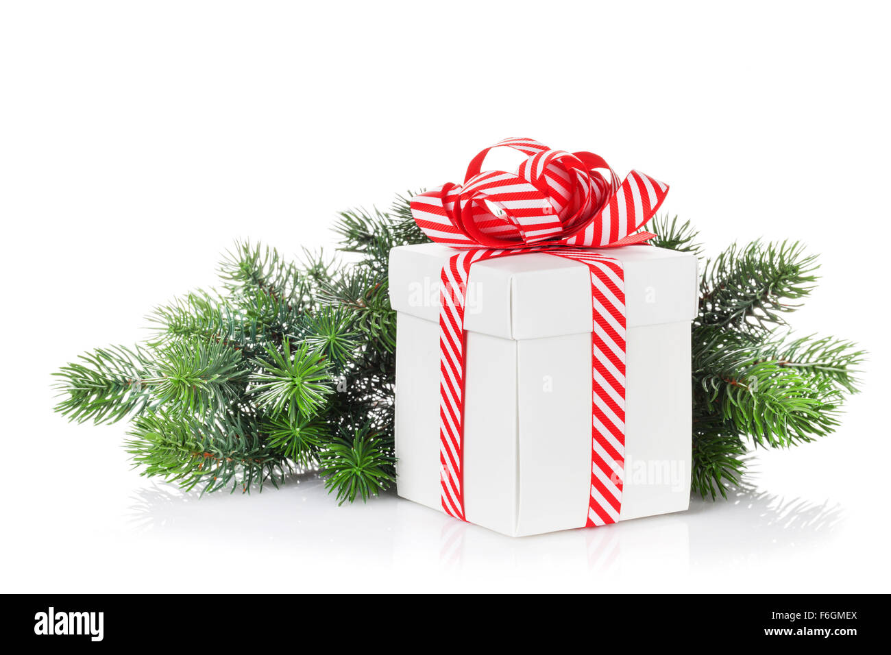 Christmas gift box and fir tree branch. Isolated on white background ...