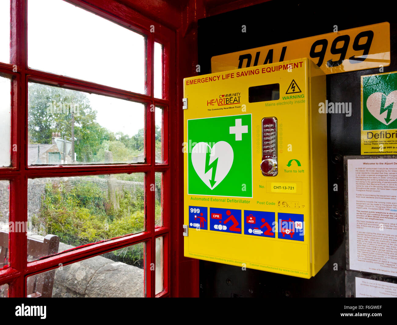 Defibrillator Emergency Life Saving Equipment installed in old red telephone box in Alport village Derbyshire Dales England UK Stock Photo