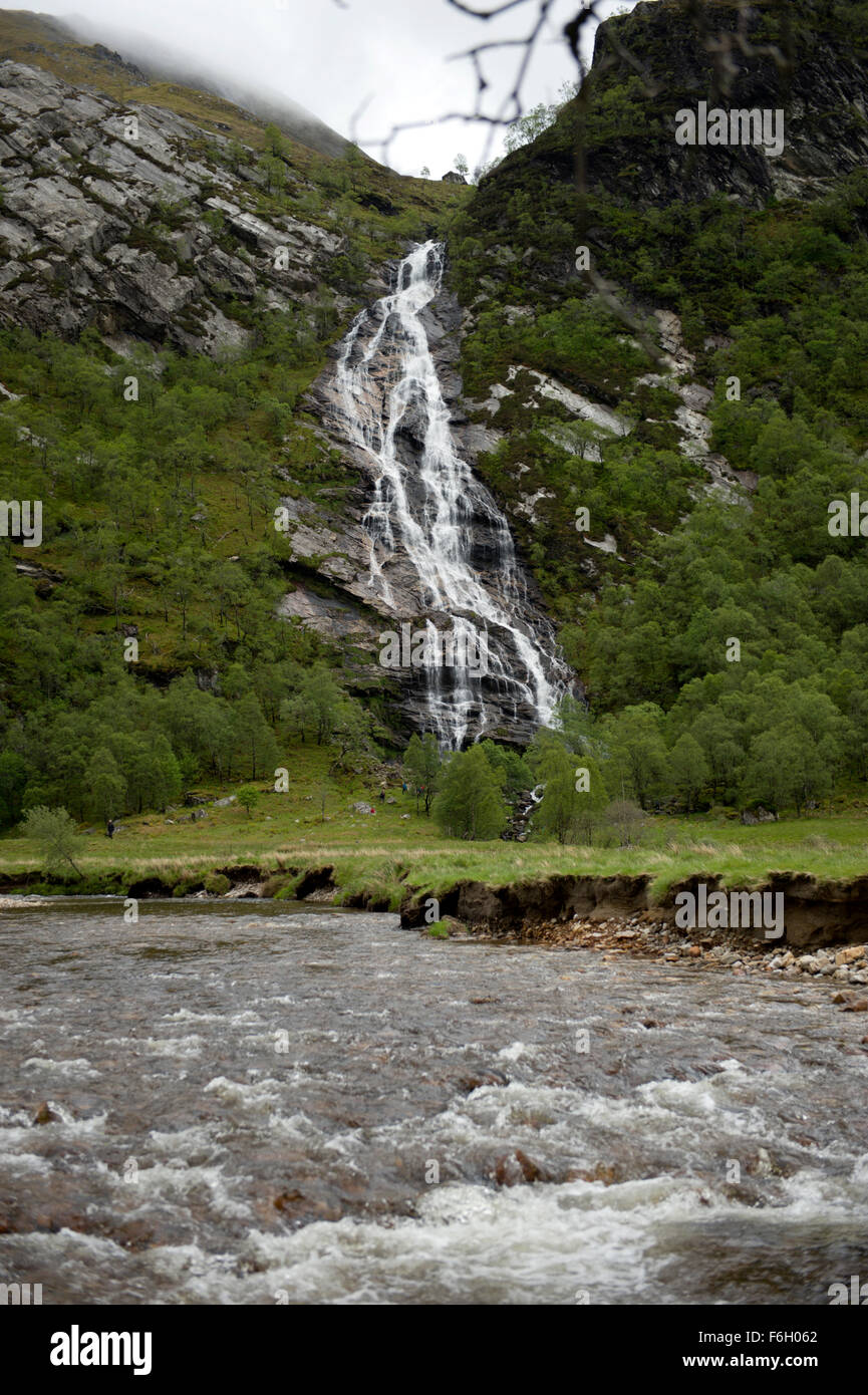 The majestic waterfalls at Steall tumbling into the water of Nevis deep in Glen Nevis Stock Photo