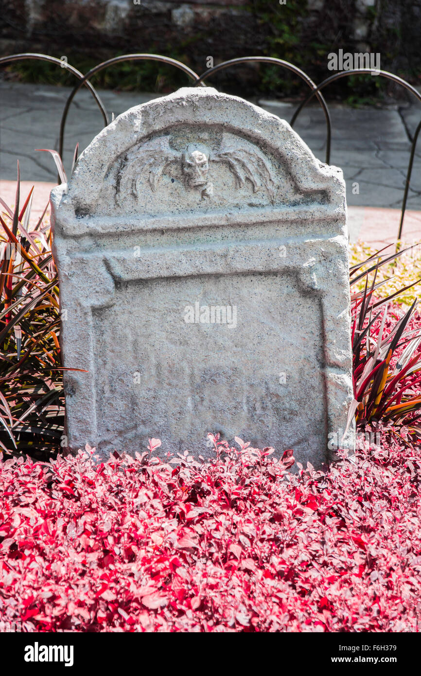 Tombstone and graves in an ancient church graveyard Stock Photo