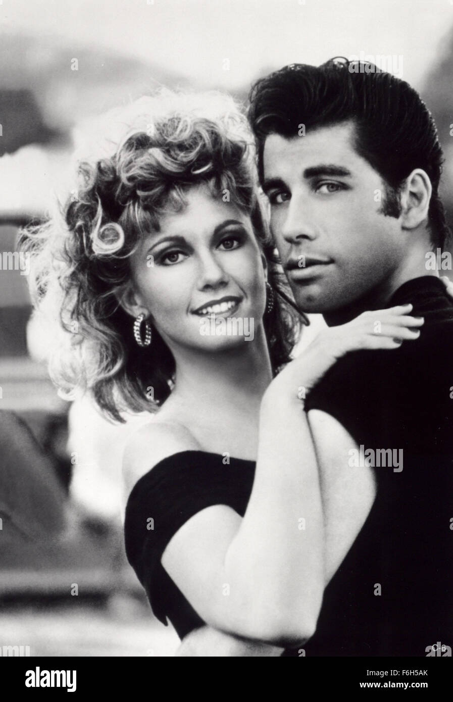 RELEASE DATE: June 16, 1978. MOVIE TITLE: Grease. STUDIO: Paramount Pictures. PLOT: Good girl Sandy and greaser Danny fell in love over the summer. But when they unexpectedly discover they're now in the same high school, will they be able to rekindle their romance?  PICTURED: OLIVIA NEWTON-JOHN as Sandy & JOHN TRAVOLTA as Danny. Stock Photo