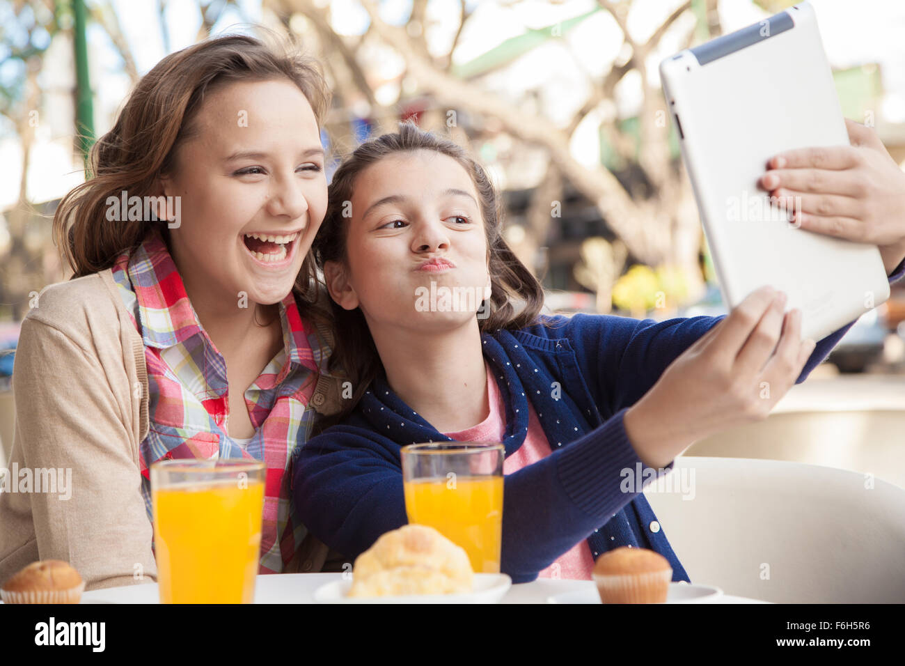 Two girls playing with the tablet Stock Photo