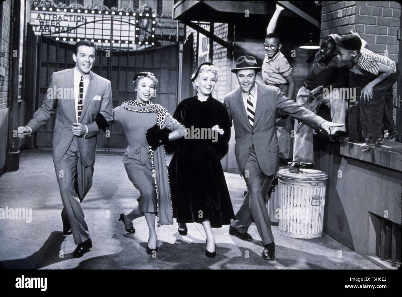 1955, Film Title: THREE FOR THE SHOW, Director: H C POTTER, Studio: COLUMBIA, Pictured: GOWER CHAMPION, MARGE CHAMPION, DANCING, BETTY GRABLE, JACK LEMMON, ARM IN ARM, ALLEY, MUSICAL, TRASH CAN. (Credit Image: SNAP) Stock Photo