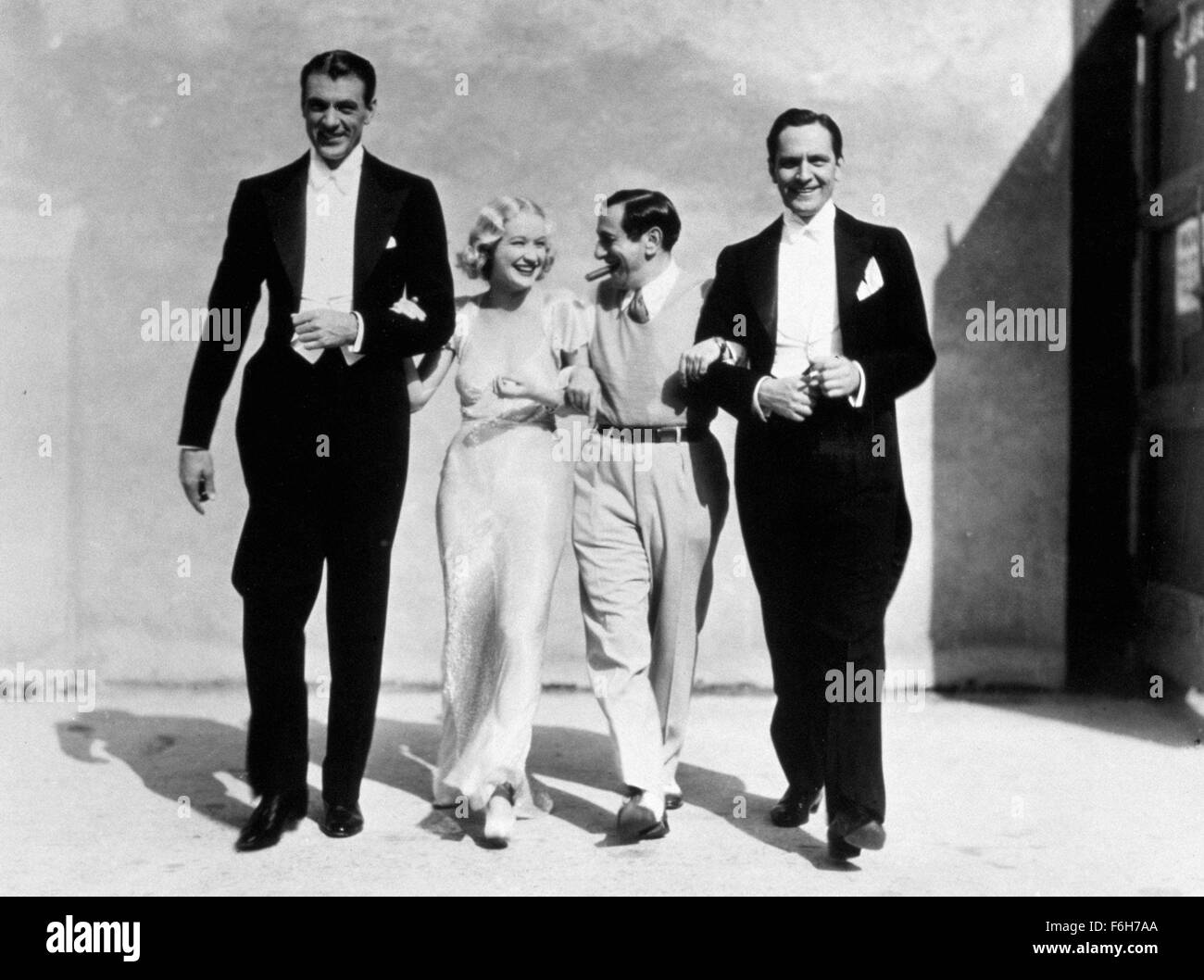 1933, Film Title: DESIGN FOR LIVING, Director: ERNST LUBITSCH, Studio: PARAMOUNT, Pictured: CLOTHING, GARY COOPER, EVENING GOWN, MIRIAM HOPKINS, ERNST LUBITSCH, FREDRIC MARCH, PARAMOUNT STUDIOS, SOUND STAGE. (Credit Image: SNAP) Stock Photo