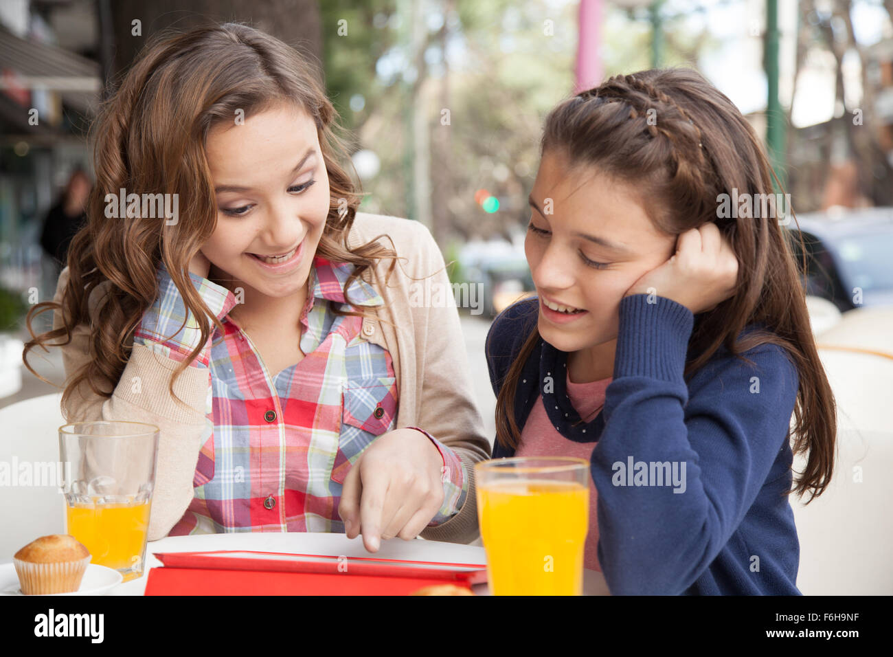 Two girls playing with the tablet Stock Photo