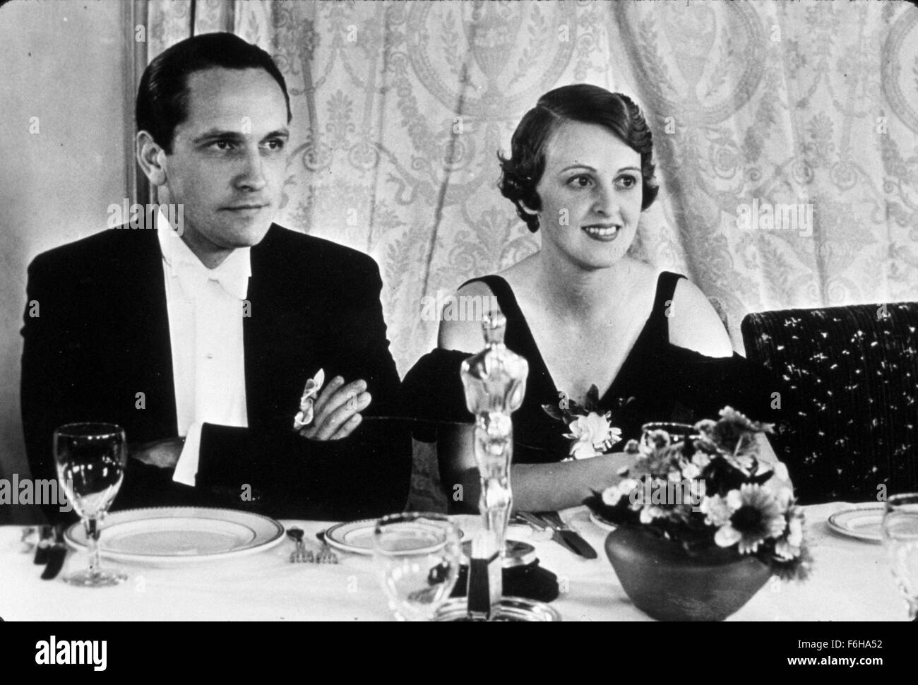 1932, Film Title: DR. JEKYLL AND MR. HYDE, Director: ROUBEN MAMOULIAN, Studio: PARAMOUNT, Pictured: 1932, ACADEMY AWARDS CEREMONIES, ACCESSORIES, LOS ANGELES AMBASSADOR HOTEL, AWARDS - ACADEMY, BEST ACTOR, FLORENCE ELDRIDGE, HUSBAND & WIFE, ROUBEN MAMOULIAN, FREDRIC MARCH, MARRIED COUPLES, OSCAR (ACADEMY AWARD STATUE), TUXEDO, SITTING, OSCAR RETRO. (Credit Image: SNAP) (Credit Image: c SNAP/Entertainment Pictures) Stock Photo