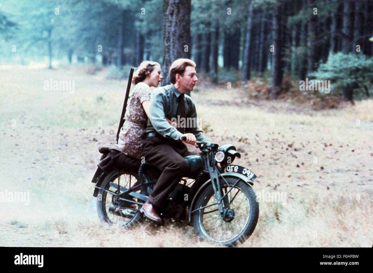 1977, Film Title: EAGLE HAS LANDED, Director: JOHN STURGES, Pictured: JENNY AGUTTER, MOTORCYCLE, GUN, DONALD SUTHERLAND, VEHICLE, TANDEM, DOUBLE, PASSENGER, FOREST, WOOD, RIDING, WAR. (Credit Image: SNAP) Stock Photo