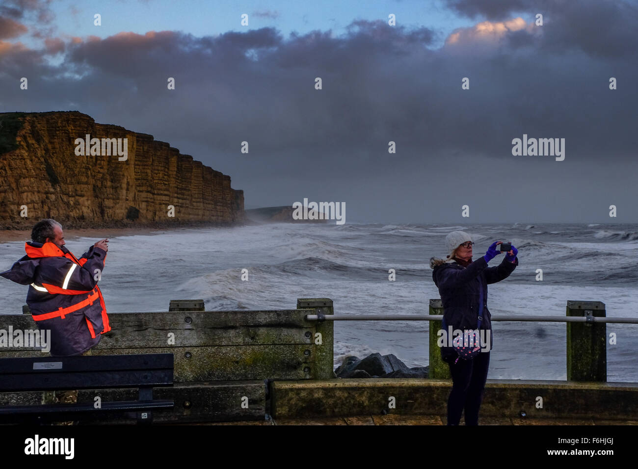 West Bay, Dorset, UK. 17th Nov, 2015. People photograph the waves at West Bay on the Dorset Coast as Storm Barney begins to make itself felt on the south coast. Gusts 40-50 mph are expected across the southern England with gusts of 50-60 likely in coastal areas. Adverse sea conditions have lead to Condor Ferries canceling high-speed ferry service to the Channel Islands stating 'wave heights are currently forecast to exceed our legal operating limits for High Speed Craft.' © Tom Corban/Alamy Live News Credit:  Tom Corban/Alamy Live News Stock Photo