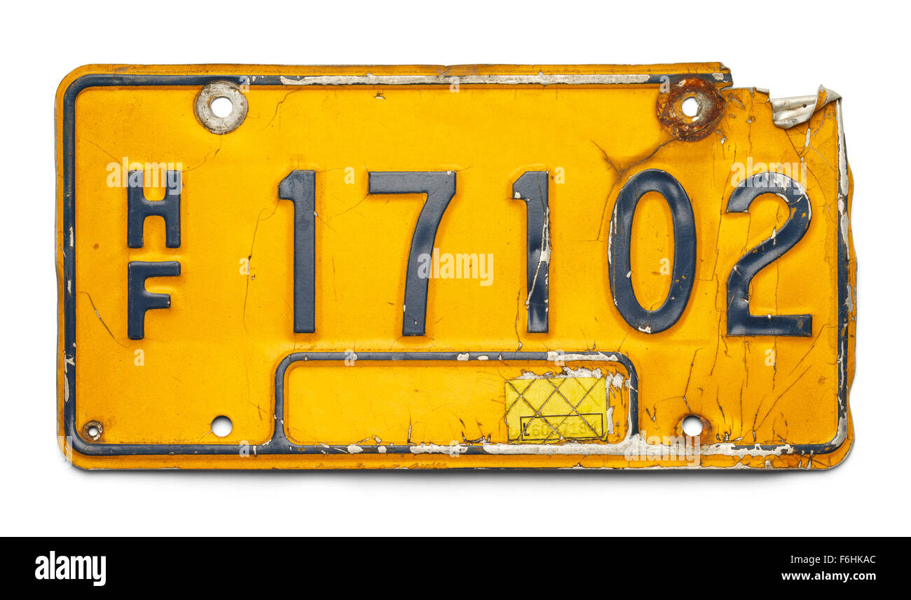 Old Yellow Bent Up License Plate Isolated on a White Background. Stock Photo