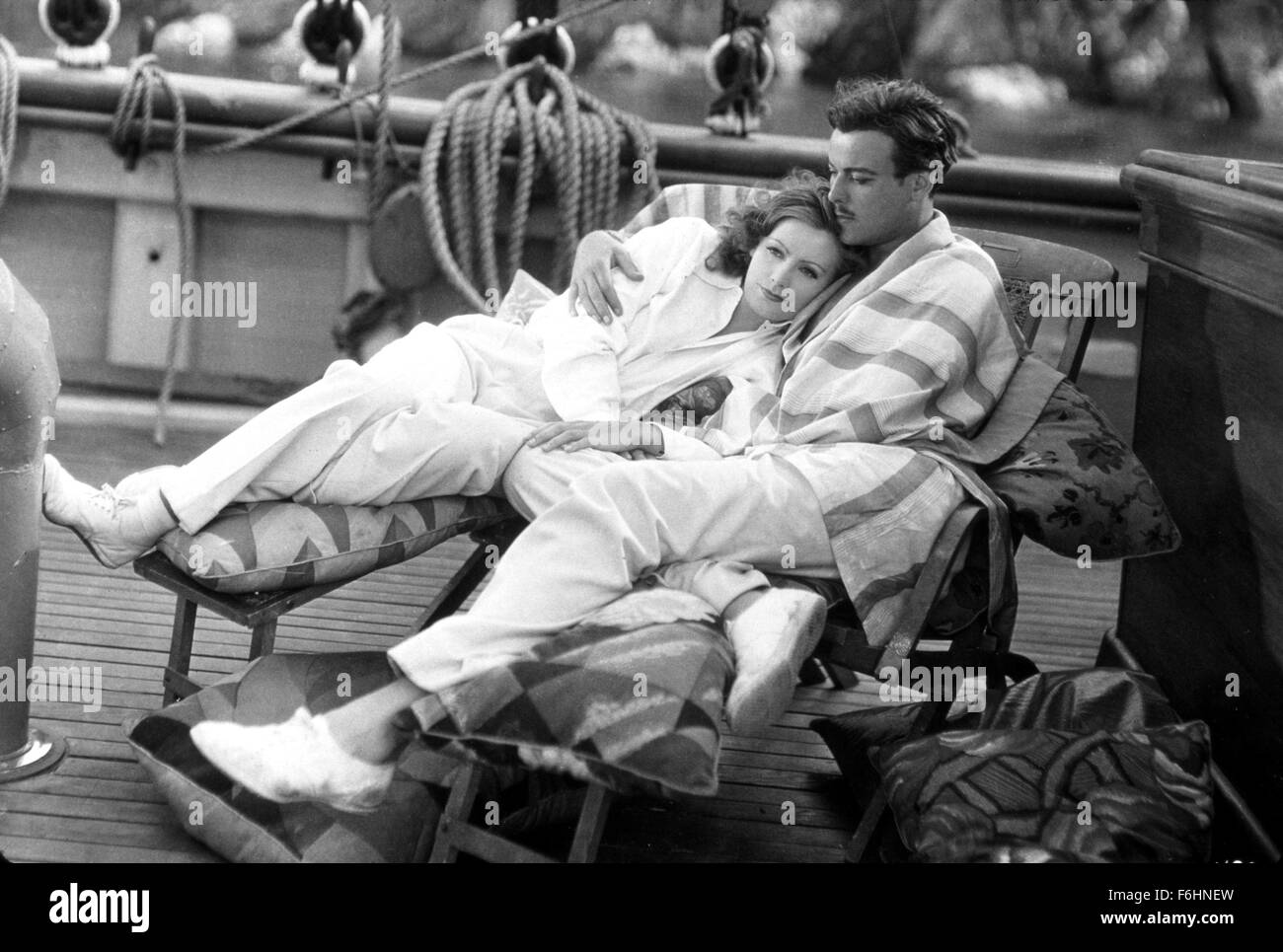 1929, Film Title: SINGLE STANDARD, Director: JOHN S ROBERTSON, Studio: MGM, Pictured: 1929, NILS ASTHER, GRETA GARBO, ROMANCE, RECLINING, BOAT, SAILING SHIP, EMBRACE, LEISURE. (Credit Image: SNAP) Stock Photo