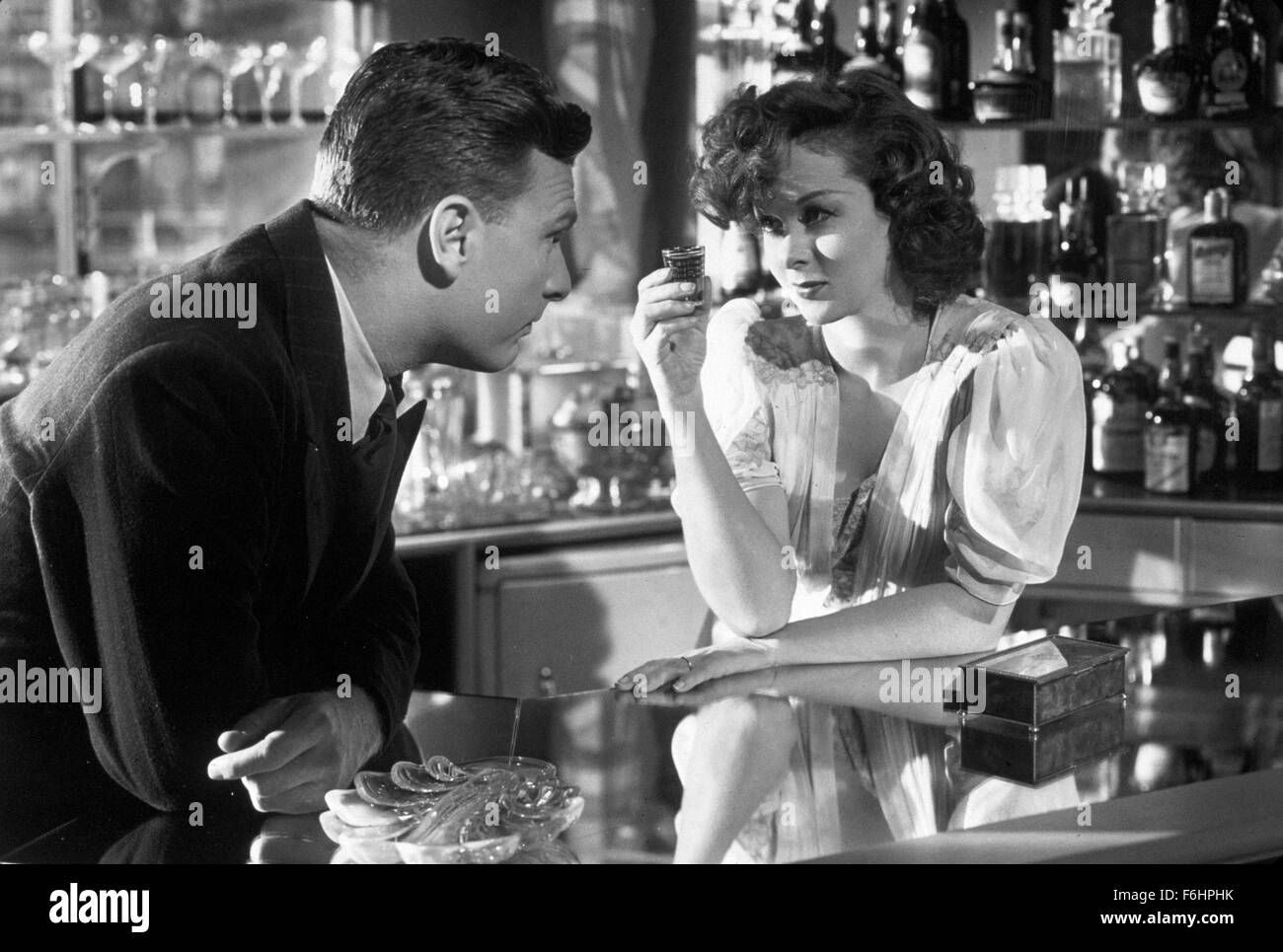 1947, Film Title: SMASH, THE STORY OF A WOMAN, Director: STUART HEISLER, Studio: UNIV, Pictured: EDDIE ALBERT, SUSAN HAYWARD, TOASTING DRINKS, SHOT, SHOOTER, SPIRIT, ALCOHOL, BAR, LEANING, GAZE. (Credit Image: SNAP) Stock Photo