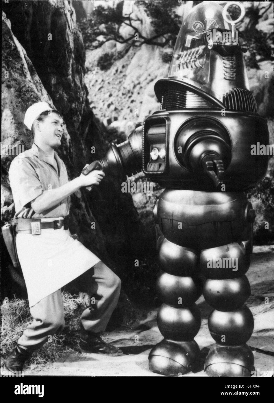 1956, Film Title: FORBIDDEN PLANET, Director: FRED McLEOD WILCOX, Studio: MGM, Pictured: EARL HOLLIMAN, ROBBY THE ROBOT, ROBOTS-ANDROIDS-CYBORGS-CLONES, SCI-FI, SPACE EXPLORATION, SHAKING HANDS, INTRODUCING, INTRODUCTION, ROBOT, ALIENS, GOOD, BEFRIENDING, FRIEND, HUMAN, THE TEMPEST. (Credit Image: SNAP) Stock Photo