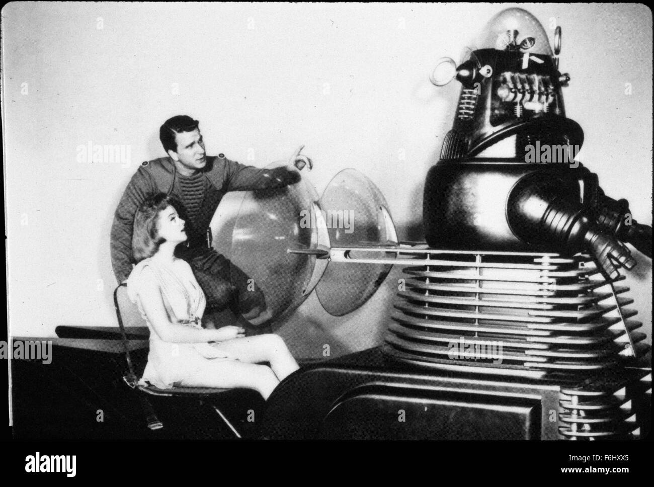 1956, Film Title: FORBIDDEN PLANET, Director: FRED McLEOD WILCOX, Studio: MGM, Pictured: ANNE FRANCIS, LESLIE NIELSEN, ROBBY THE ROBOT, ROBOTS-ANDROIDS-CYBORGS-CLONES, SCI-FI, SPACE EXPLORATION, ROBOT, ALIEN, FRIENDLY, GOOD, POINTING, LEARNING, EDUCATION, EXPLAINING, SHOWING, THE TEMPEST. (Credit Image: SNAP) Stock Photo