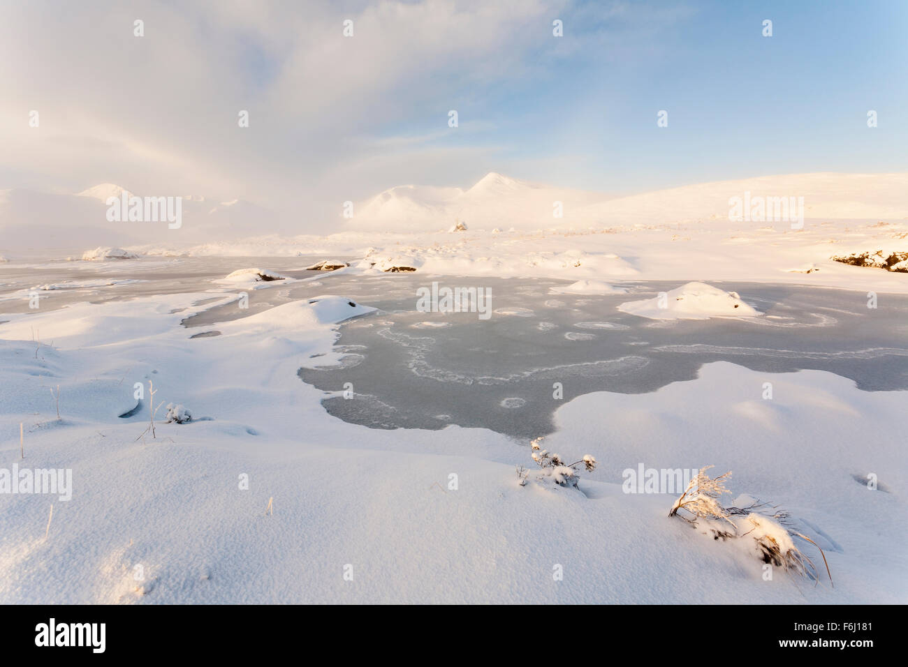 A thick blanket of snow on the shores of Lochan na Stainge, Rannoch Moor, Scotland, seen just after sunrise Stock Photo