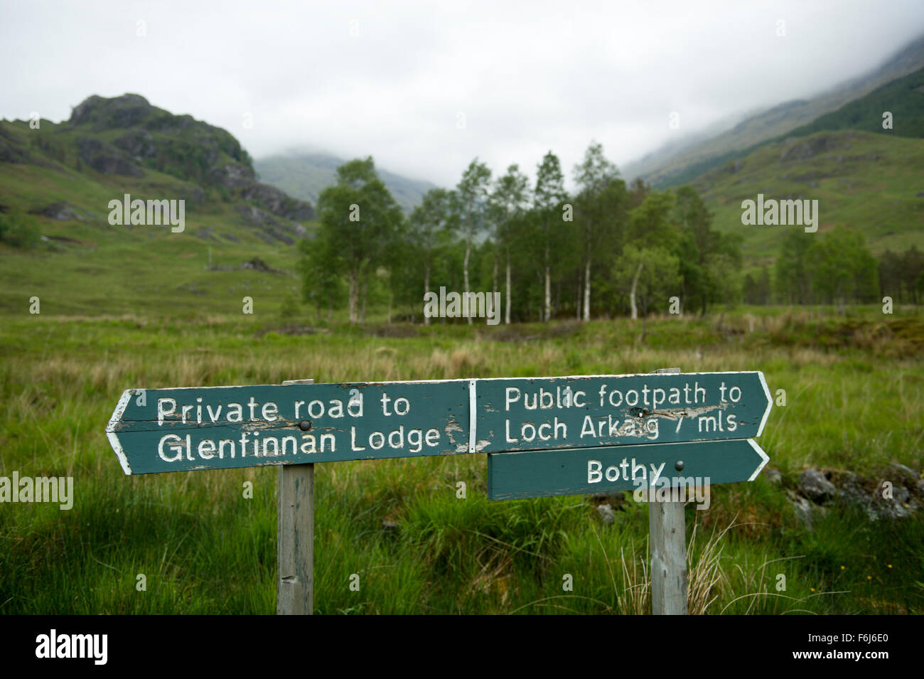 Signs at the head of Glen Finnan pointing the way via a private road to Glenfinnan Lodge and footpath to Loch Arkaig Stock Photo