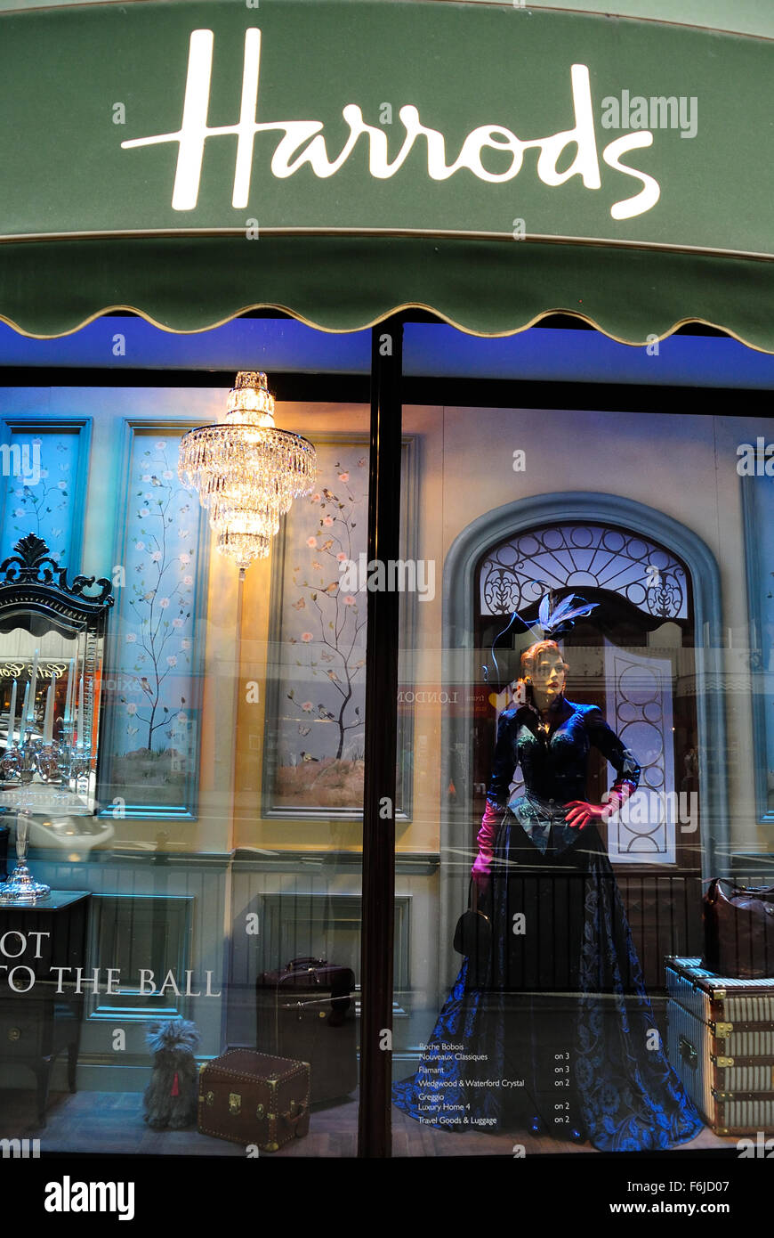 Women's wear  displayed in Harrods' shop window, Knightsbridge, London, UK - evening, 2015 Stock Photo