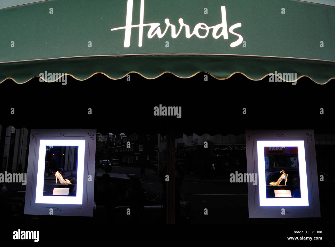 Shoes are displayed for sale in the shop window of Harrods; an upmarket department store in Knightsbridge, London UK Stock Photo