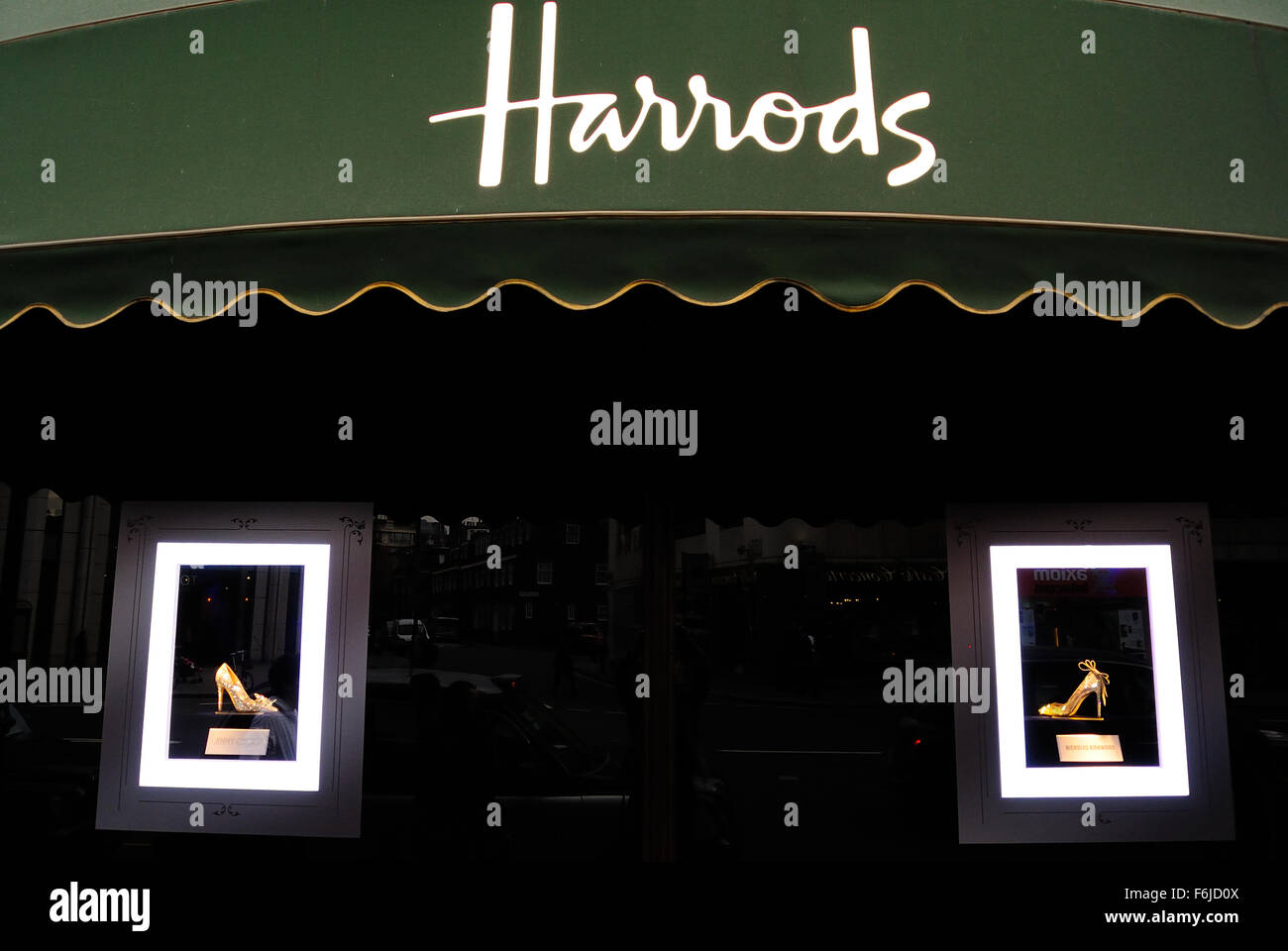 Shoes are displayed for sale in the shop window of Harrods; an upmarket department store in Knightsbridge, London UK Stock Photo