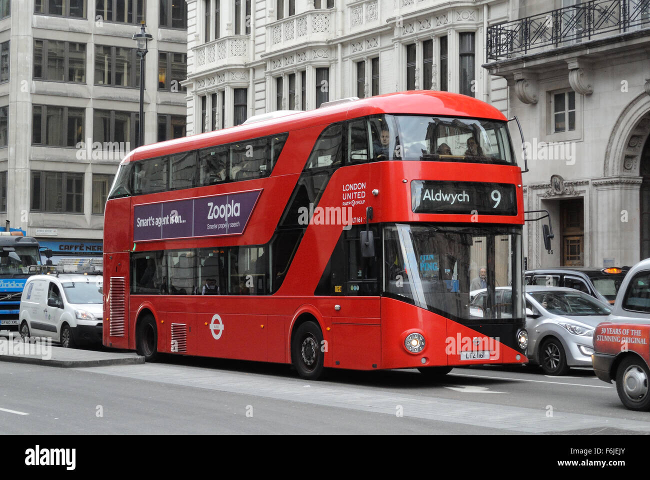 A traditional double decker Routemaster bus navigates traffic in Piccadilly, central London, England - 2015 Stock Photo