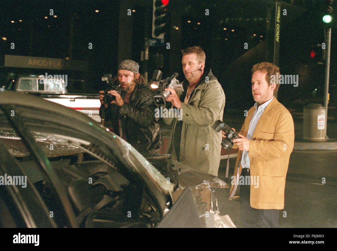 RELEASE DATE: September 3, 2004. MOVIE TITLE: Paparazzi. STUDIO: 20th Century Fox. PLOT: A rising Hollywood actor decides to take personal revenge against a group of four persistent photographers to make them pay for almost causing a personal tragedy involving his wife and son. PICTURED: KEVIN GAGE as Kevin Rosner, DANIEL BALDWIN as Wendell Stokes and TOM HOLLANDER as Leonard Clark. Stock Photo