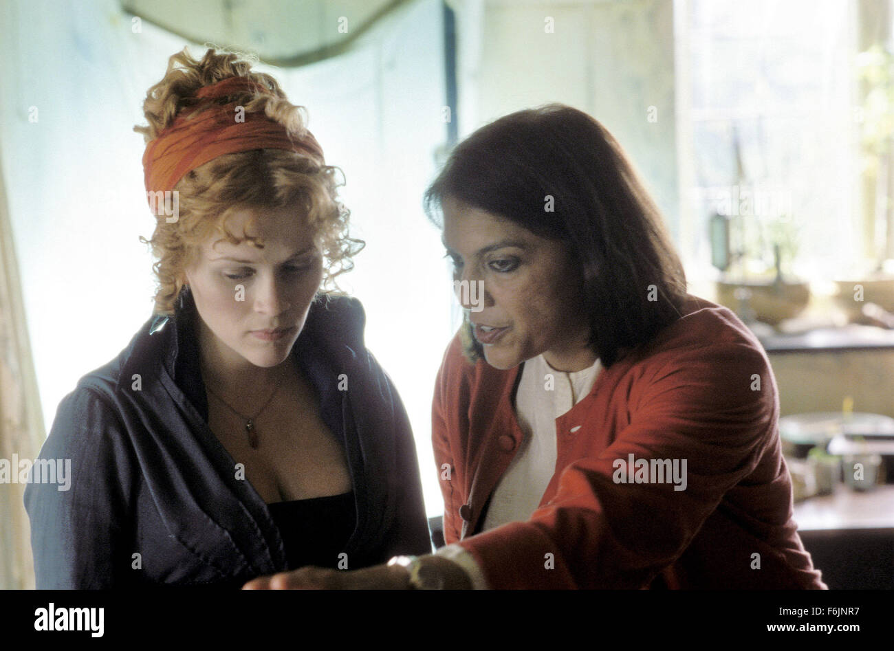 RELEASE DATE: September 1, 2004. MOVIE TITLE: Vanity Fair. STUDIO: Focus Features. PLOT: Growing up poor in London, Becky Sharp (Witherspoon) defies her poverty-stricken background and ascends the social ladder alongside her best friend, Amelia. PICTURED: Director MIRA NAIR goes over a scene with actress RESSE WITHERSPOON. Stock Photo