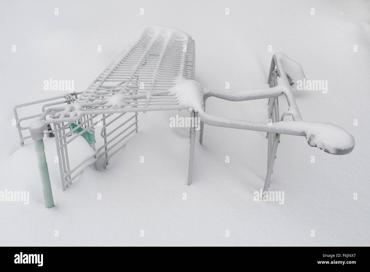 Shopping cart turned on its side and covered in snow Stock Photo Alamy