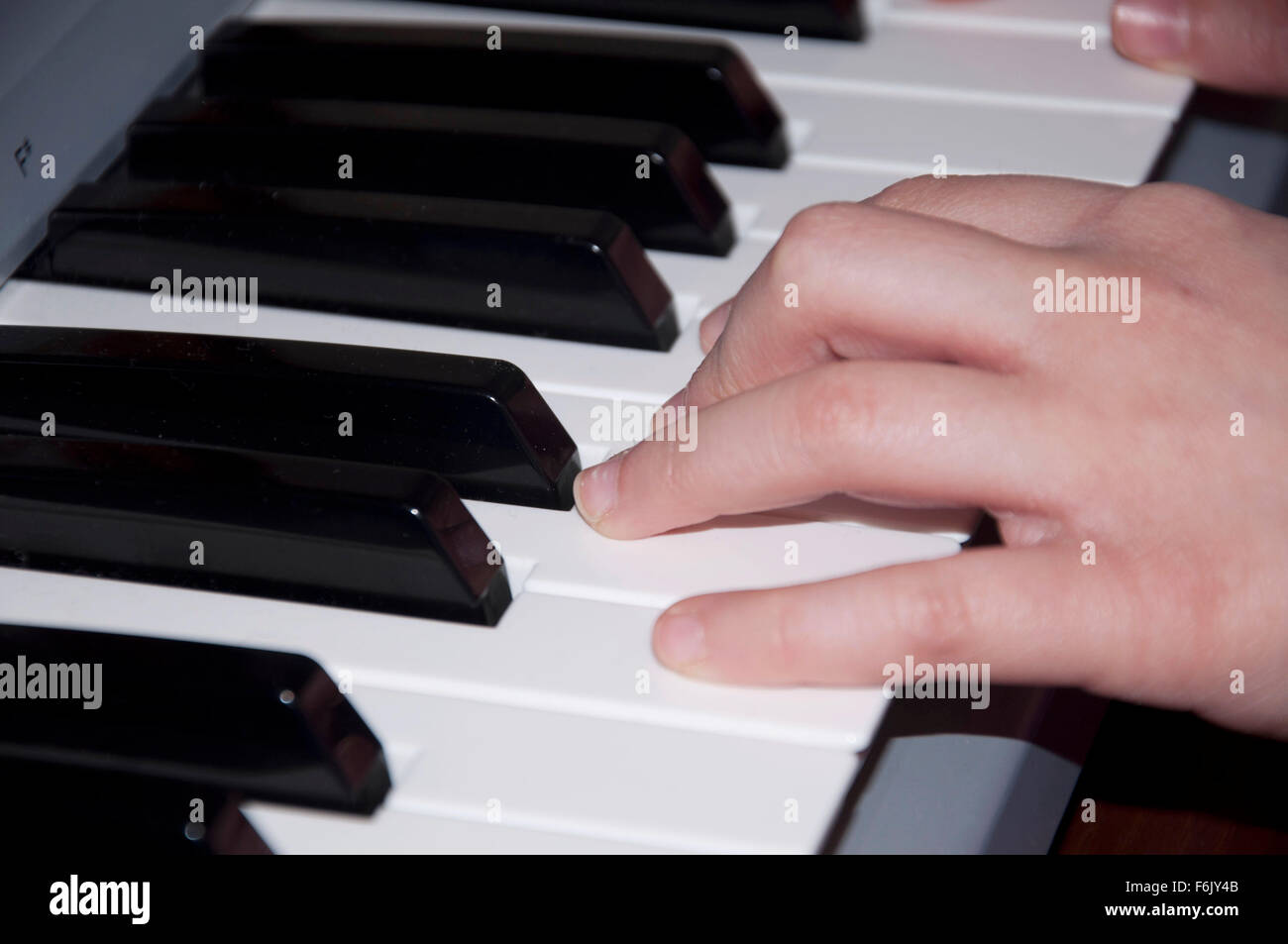 Hand over the piano keyboard playing music Stock Photo