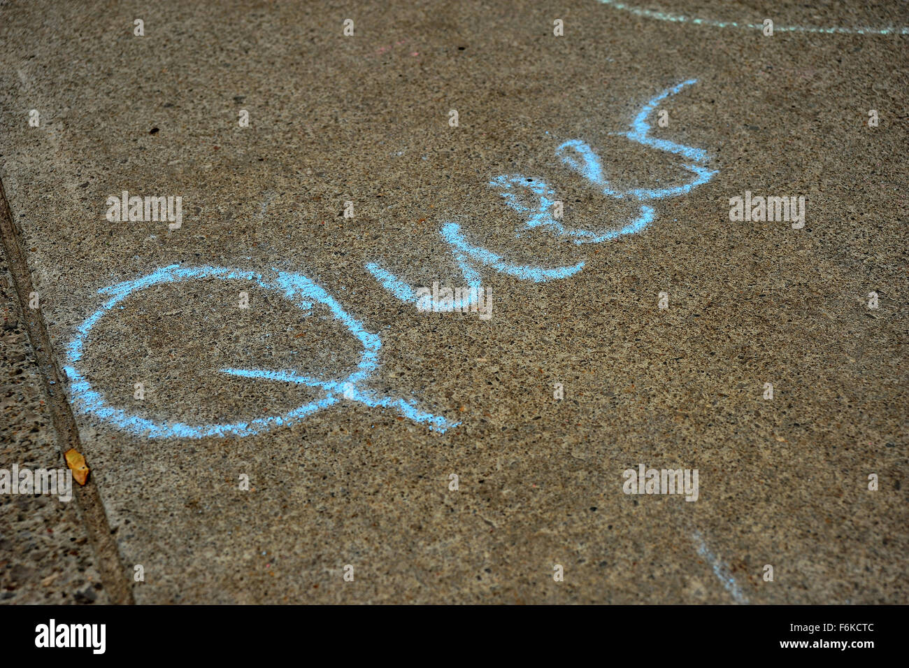 Queer written on the ground in chalk at London, Ontario pride. Stock Photo