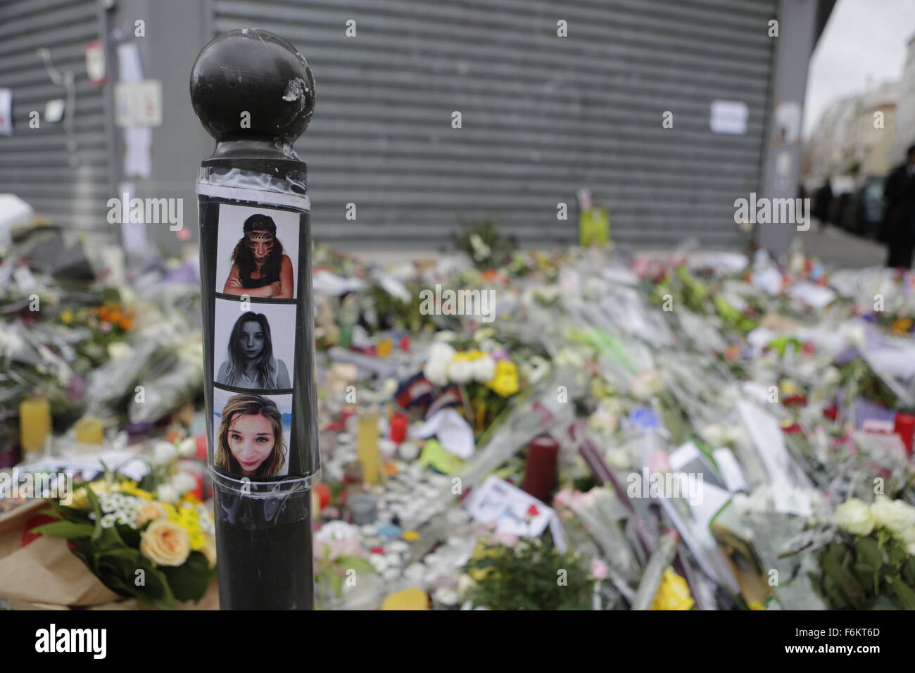 Paris, France. 17th November 2015. Pictures of some of the victims have been placed at the memorial outside the restaurant Le Petit Cambodge for the people killed here during the Paris attacks. Parisians and tourists continue to visit the memorials for the people killed in the terrorists attacks in Paris, to lay down flowers and candles and to pay their respect. Over 130 people have been by terrorist from the Islamic State. Stock Photo