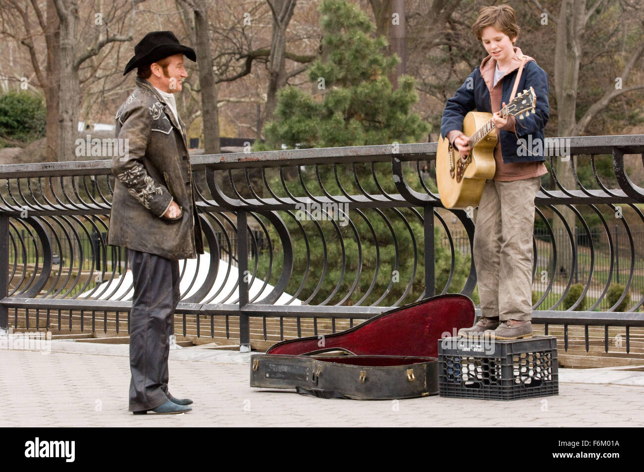 RELEASE DATE: Oct 21, 2007. MOVIE TITLE: August Rush. STUDIO: CJ Entertainment. PLOT: The story of a charismatic young Irish guitarist and a sheltered young cellist who have a chance encounter one magical night above New York's Washington Square, but are soon torn apart, leaving in their wake an infant, August Rush, orphaned by circumstance. Now performing on the streets of New York and cared for by a mysterious stranger, August uses his remarkable musical talent to seek the parents from whom he was separated at birth. PICTURED: ROBIN WILLIAMS as Maxwell 'Wizard' Wallace, FREDDIE HIGHMORE as E Stock Photo