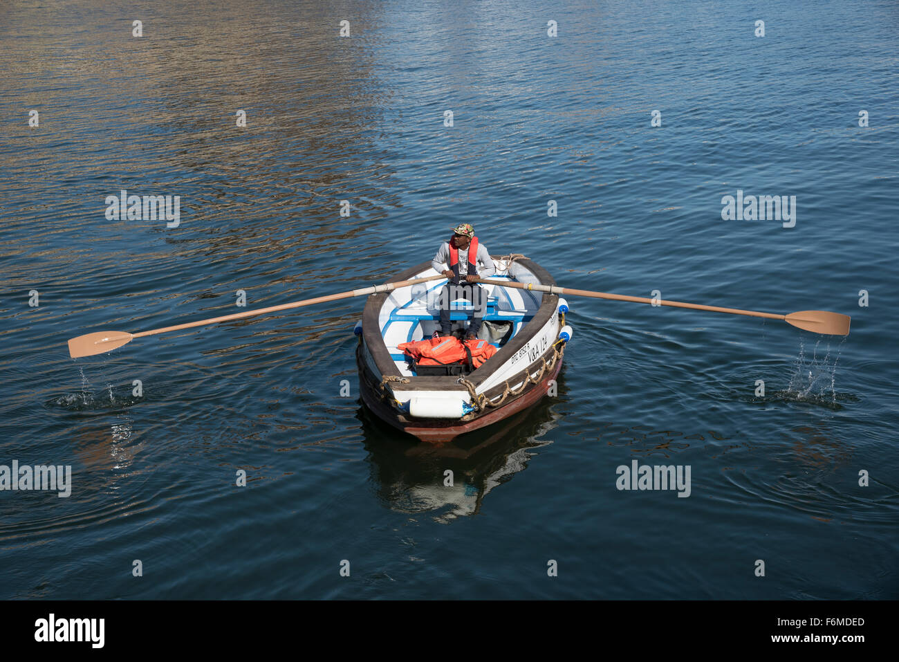 The Penny Ferry man rowing his water taxi Cape Town harbour South Africa Stock Photo