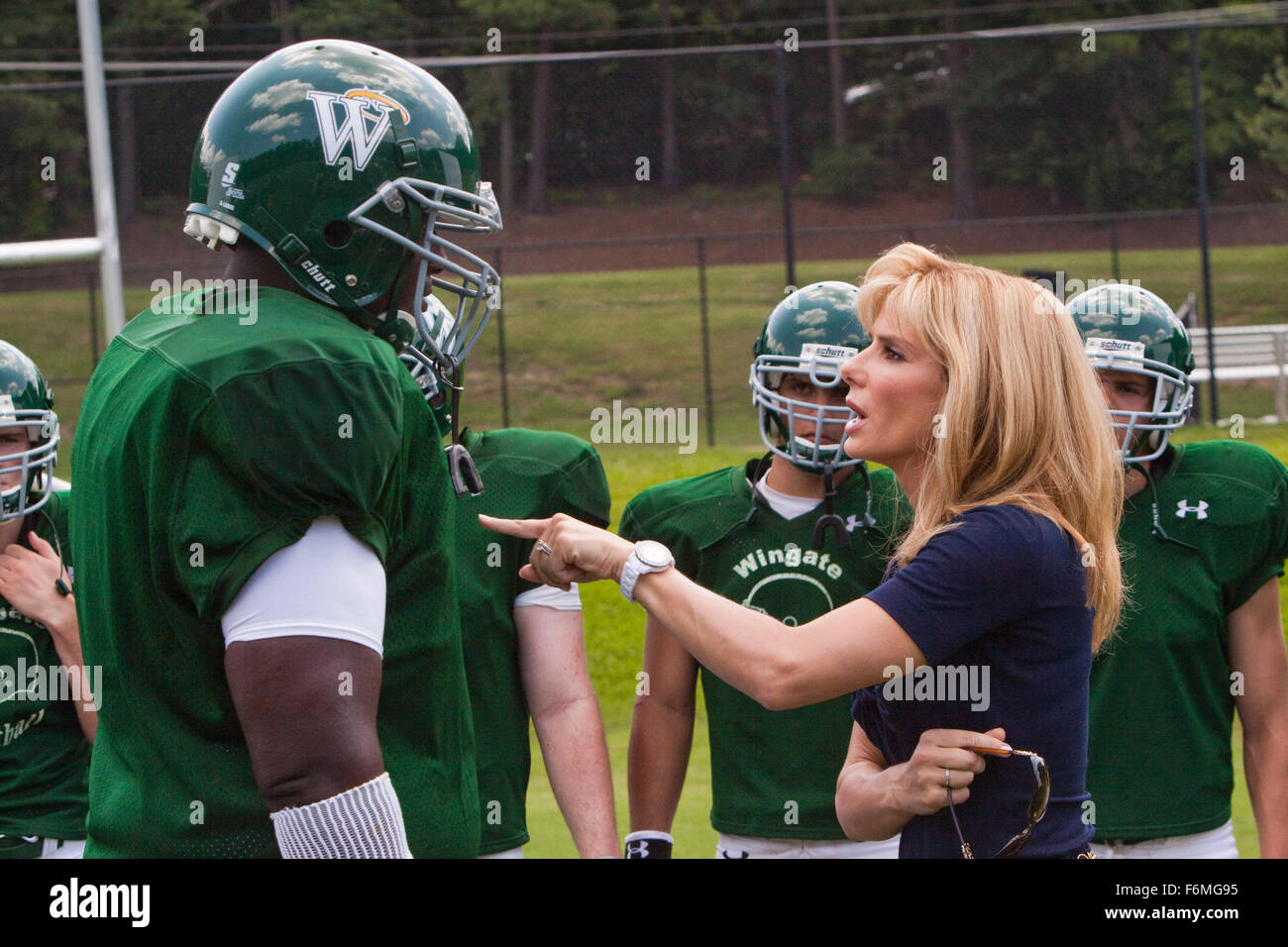 RELEASE DATE: November 20, 2009. MOVIE TITLE: The Blind Side. STUDIO: Alcon Entertainment. PLOT: The story of Michael Oher, a homeless and traumatized boy who became an All American football player and first round NFL draft pick with the help of a caring woman and her family. PICTURED: QUINTON AARON as Michael Oher and SANDRA BULLOCK as Leigh Anne Tuohy Stock Photo